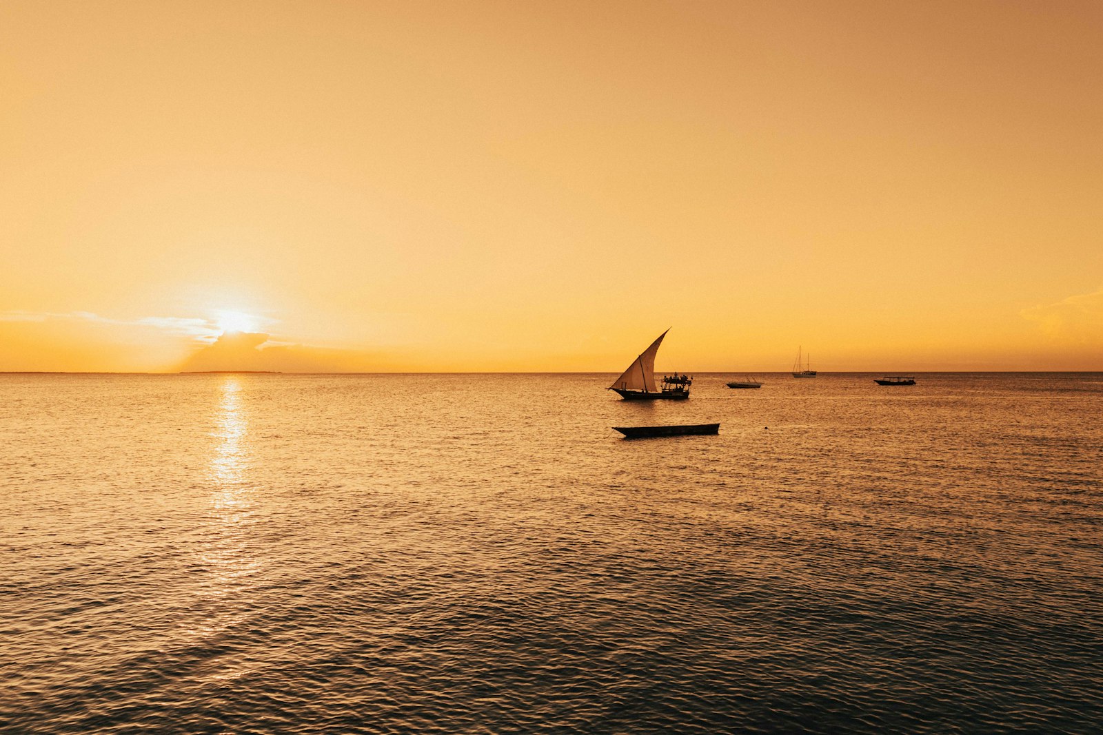 Silhouette of a sailboat against a Zanzibar sunset